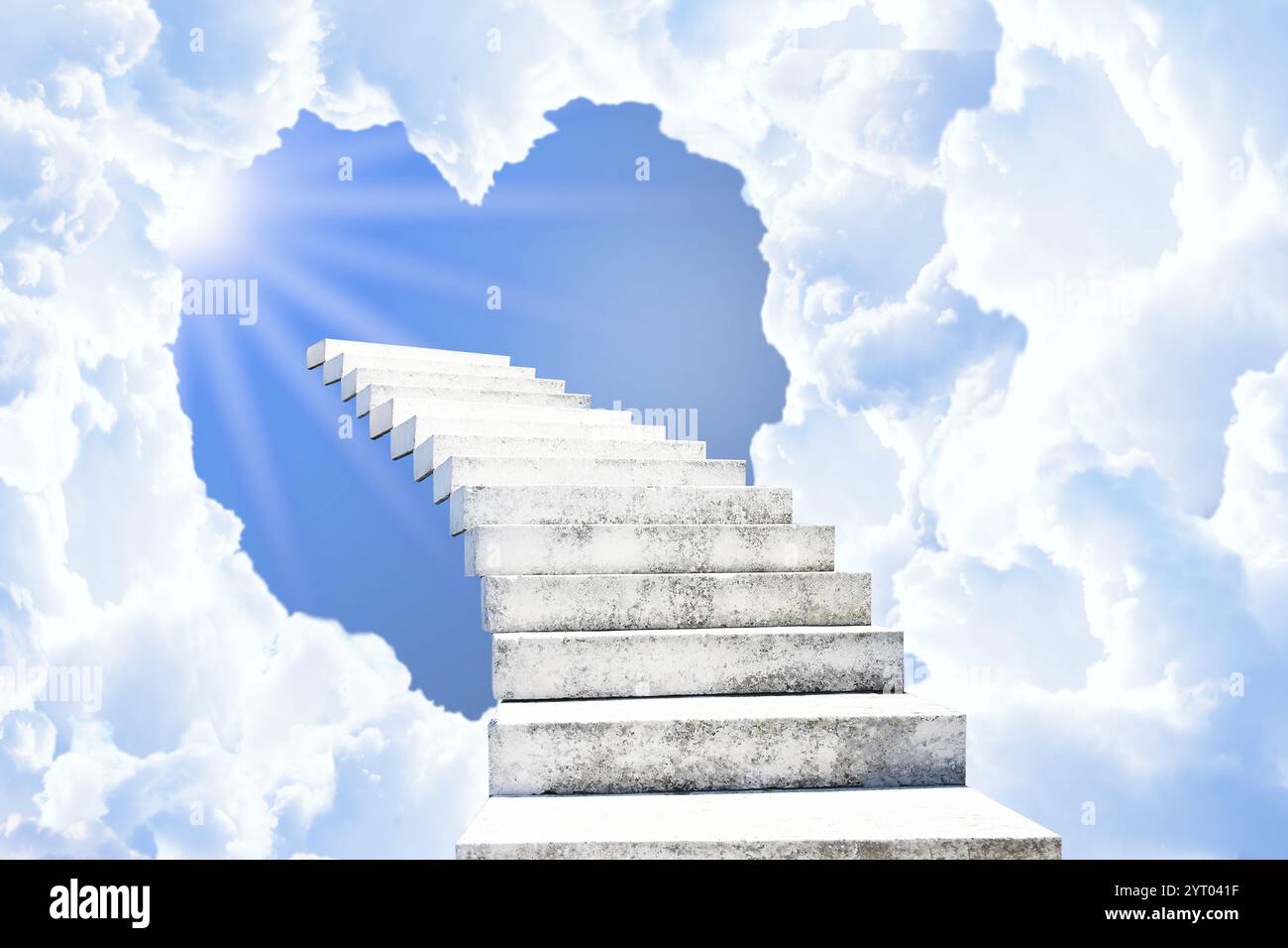 Stairs leading to light in sky through heart shaped gap in clouds. Love of God, concept Stock Photo