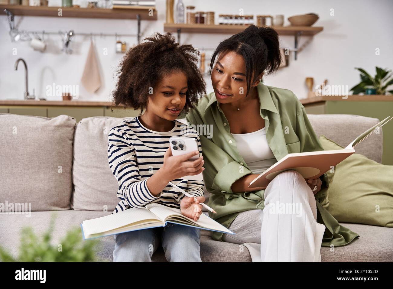 A mother and her daughter share joyful moments while reading and ...