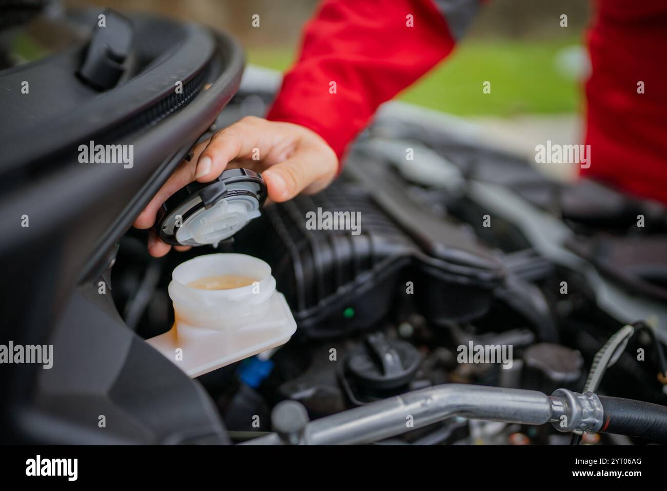 Inspecting and Checking the Fluid Levels in a Cars Engine Compartment Thoroughly Stock Photo