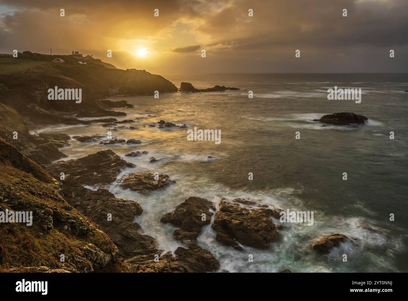 Sunrise over Lizard Point across Polpeor Cove, Cornwall, England ...