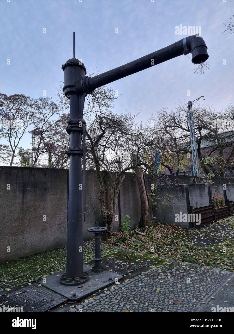 Historic water crane for steam locomotives in Nature Park Schöneberger Südgelände on the former Tempelhof railway yard in Berlin, Germany - Smartphone Captured Stock Image