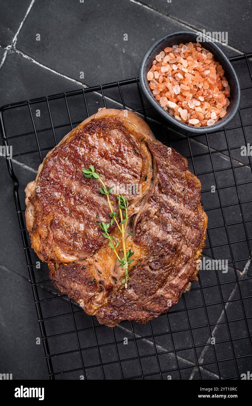 Grilled Rib eye steak on black rack, roasterd prime dry aged beef meat ...
