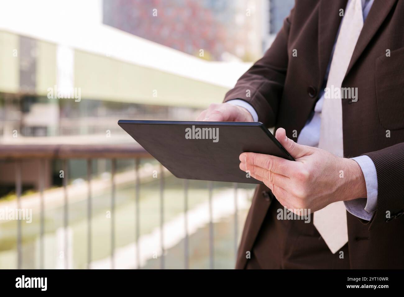 close up of unrecognizable man browsing tablet Stock Photo