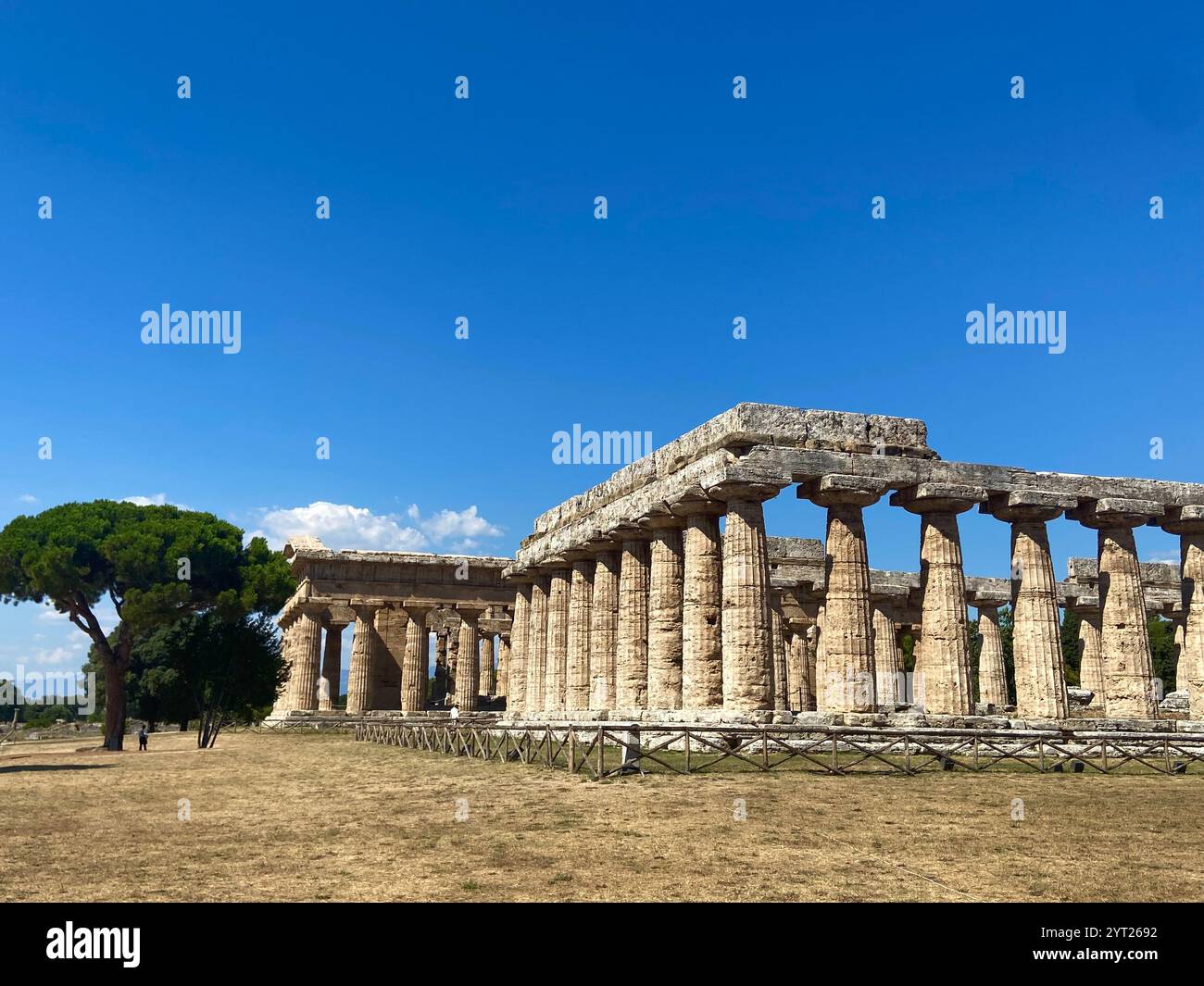 Ancient Greek Temple Ruins in Paestum, Italy, Under a Clear Blue Sky ...