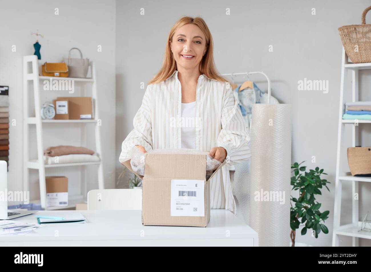 Female seller packing parcel hi-res stock photography and images - Alamy
