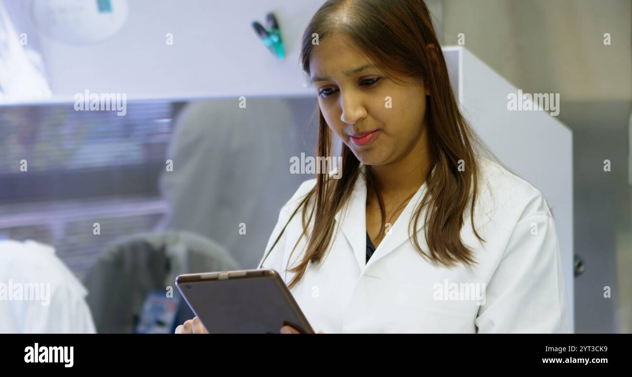 Beautiful scientist using digital tablet in laboratory Stock Photo