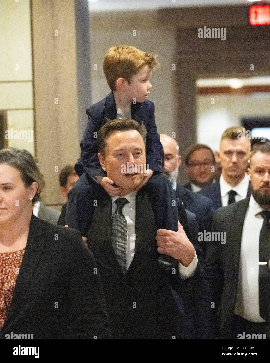 Washington, United States. 05th Dec, 2024. Elon Musk, with his son “X” on  his head, enters the Department of Government Efficiency (DOGE) meeting  with Speaker of the US House of Representatives Mike