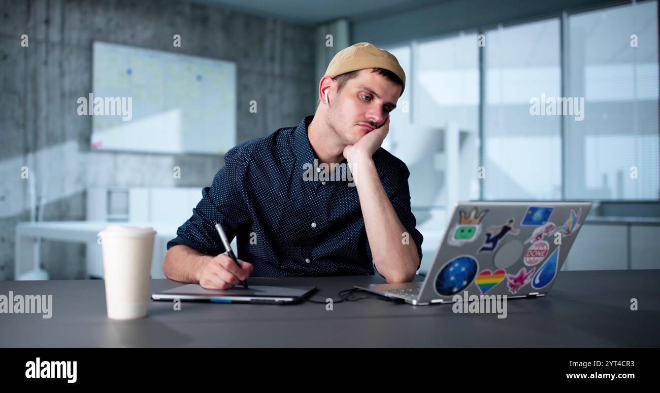 Tired Unhappy Graphics Designer Man Using Laptop Stock Photo