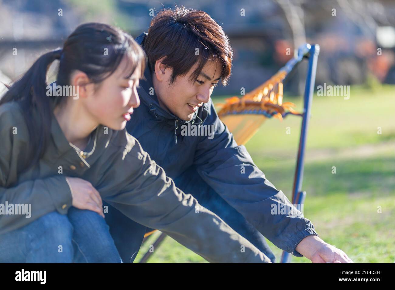 Man and woman roasting marshmallows Stock Photo