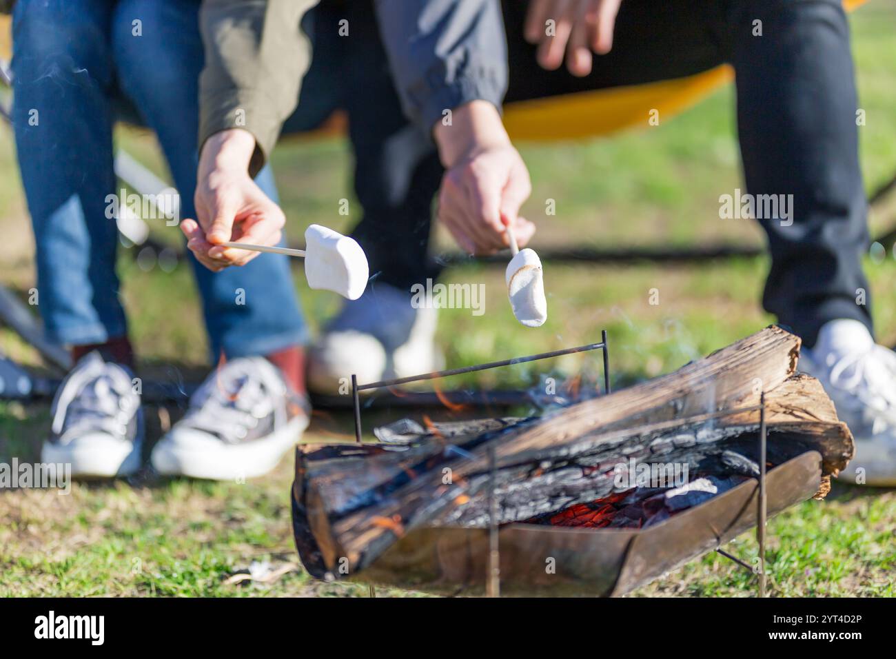 Man and woman roasting marshmallows Stock Photo