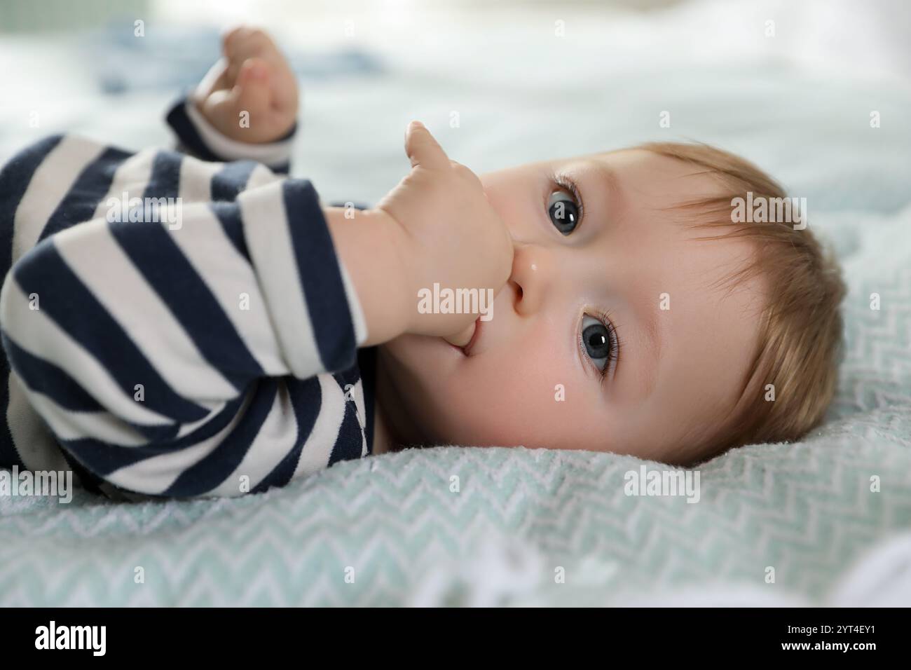 Cute little baby on bed at home Stock Photo - Alamy