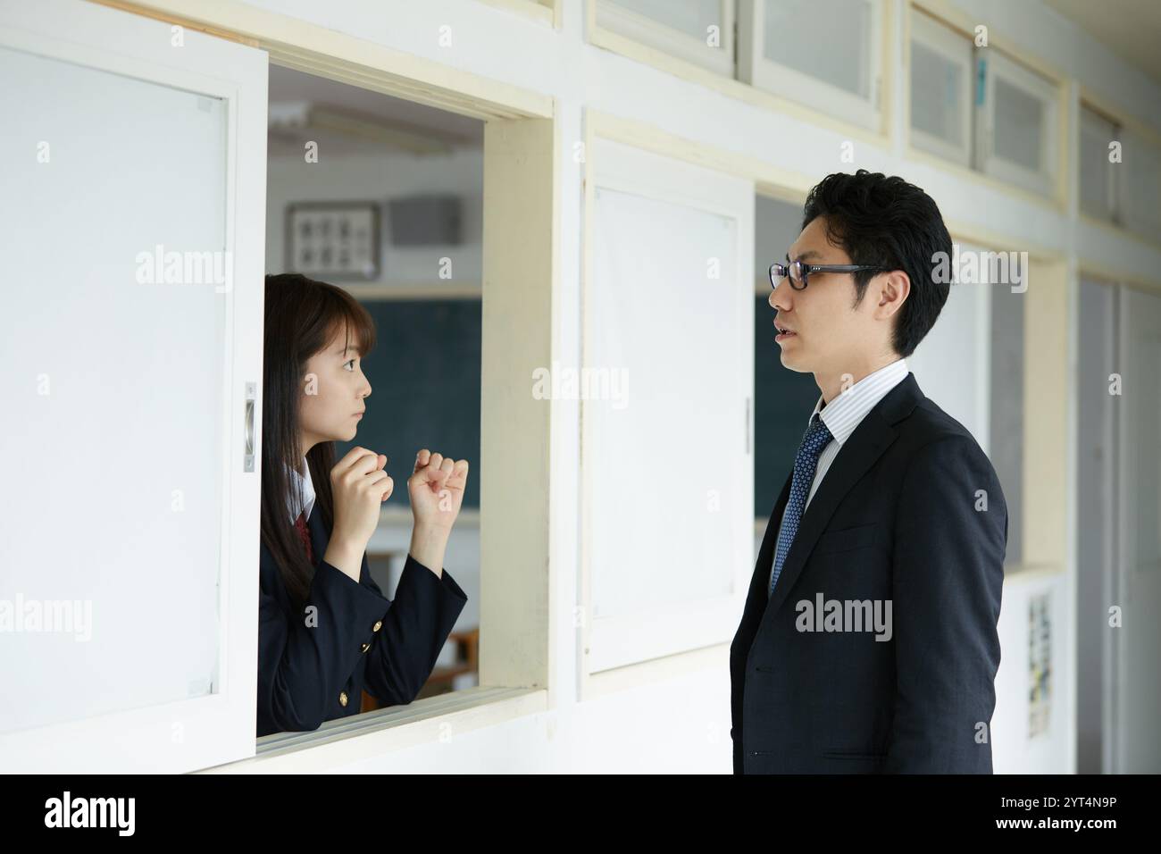 Male teacher and female high school student talking Stock Photo - Alamy