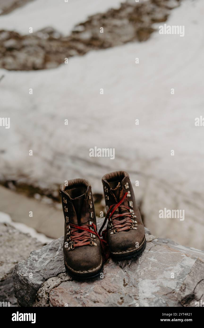 Close-Up of Vintage Hiking Boots on a Rocky Surface in the Alps Stock Photo