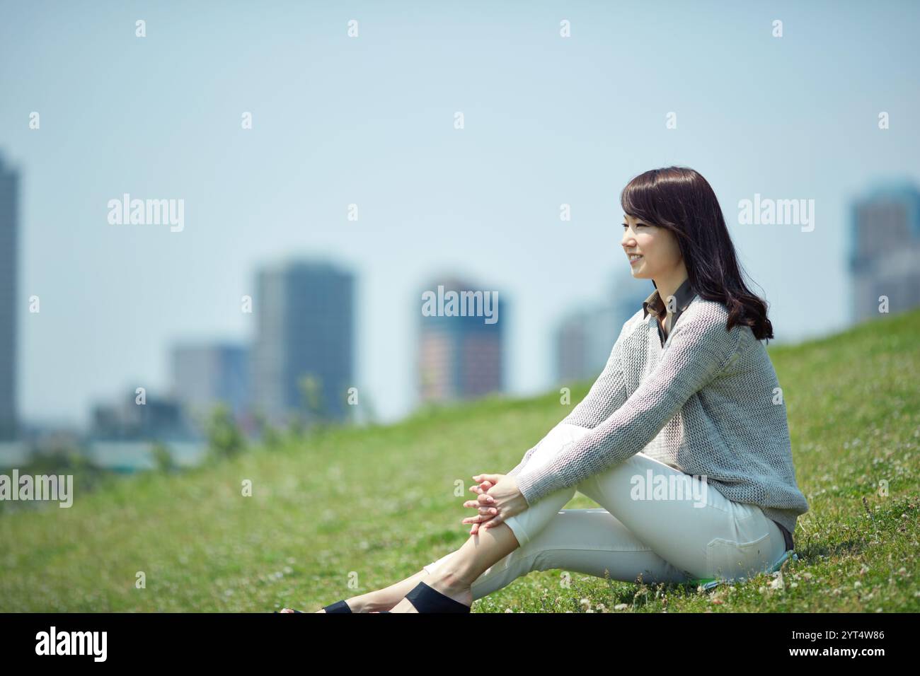 Female sitting on lawn Stock Photo - Alamy