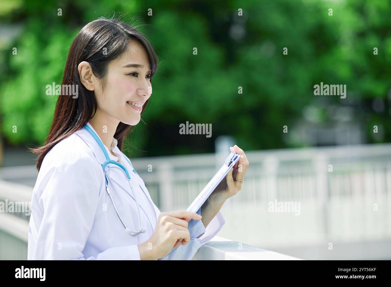 Woman in white coat Stock Photo - Alamy