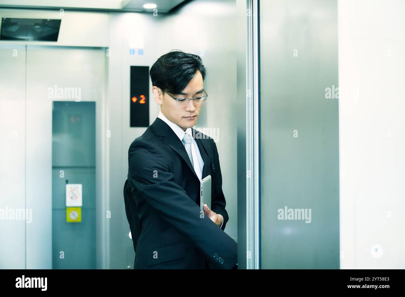 Businessman in lift hi-res stock photography and images - Alamy