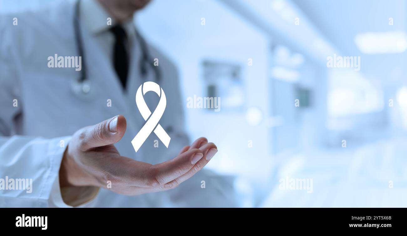 A doctor opens their palm to display a ribbon icon, symbolizing the ...