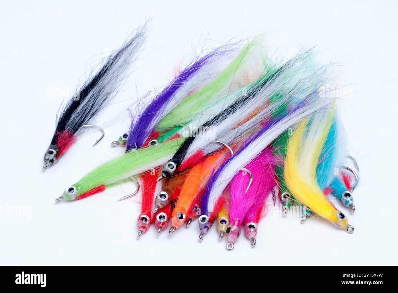 Pile of Pike, Salmon or Bass Fly Lures on size 1/0 Barbed Hooks on a white background Stock Photo