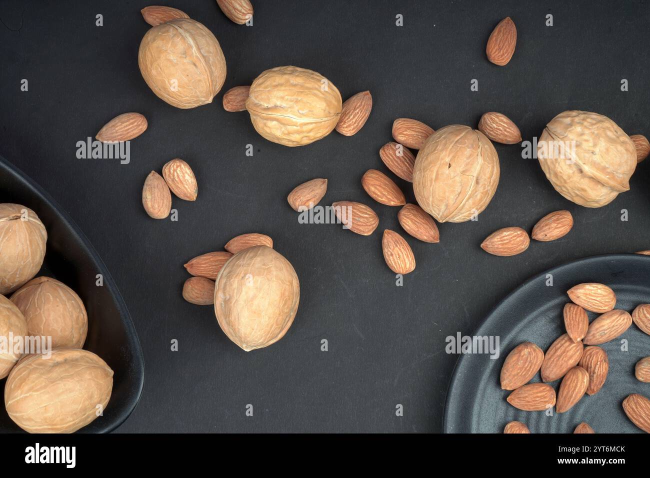 Almonds and walnut flat lay shoot in black background Stock Photo