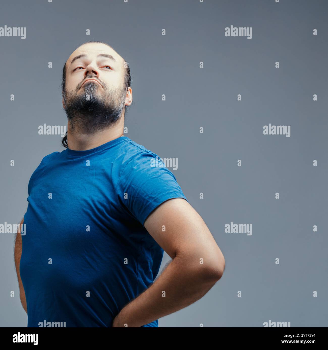 Studio Shot Featuring A Proud Man Puffing Out His Chest While Looking Studio Shot Featuring A Proud Man Puffing Out His Chest While Looking