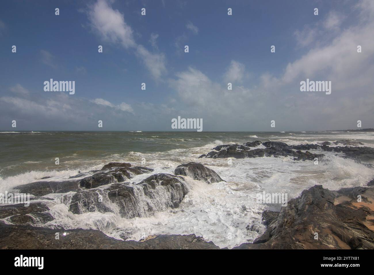 Beach with plamen and vegetation, view of the sea in the evening at sunset. Landscape with clouds in Induruwa, Bentota Beach, Sri Lanka, India, Asia Stock Photo