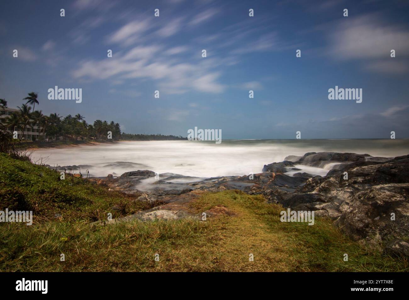 Beach with plamen and vegetation, view of the sea in the evening at sunset. Landscape with clouds in Induruwa, Bentota Beach, Sri Lanka, India, Asia Stock Photo