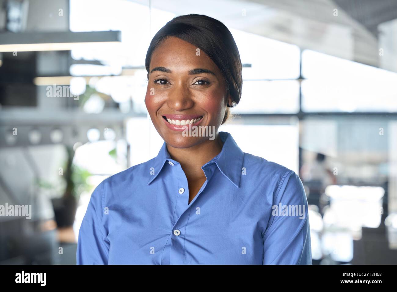 Confident smiling young African business woman in office, headshot portrait. Stock Photo