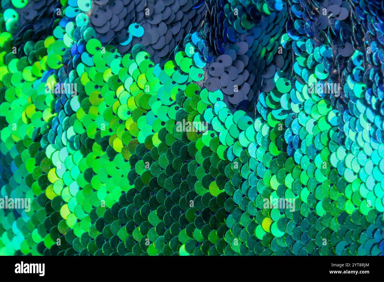 Full frame abstract background showing lots of green and blue reflective sequins Stock Photo