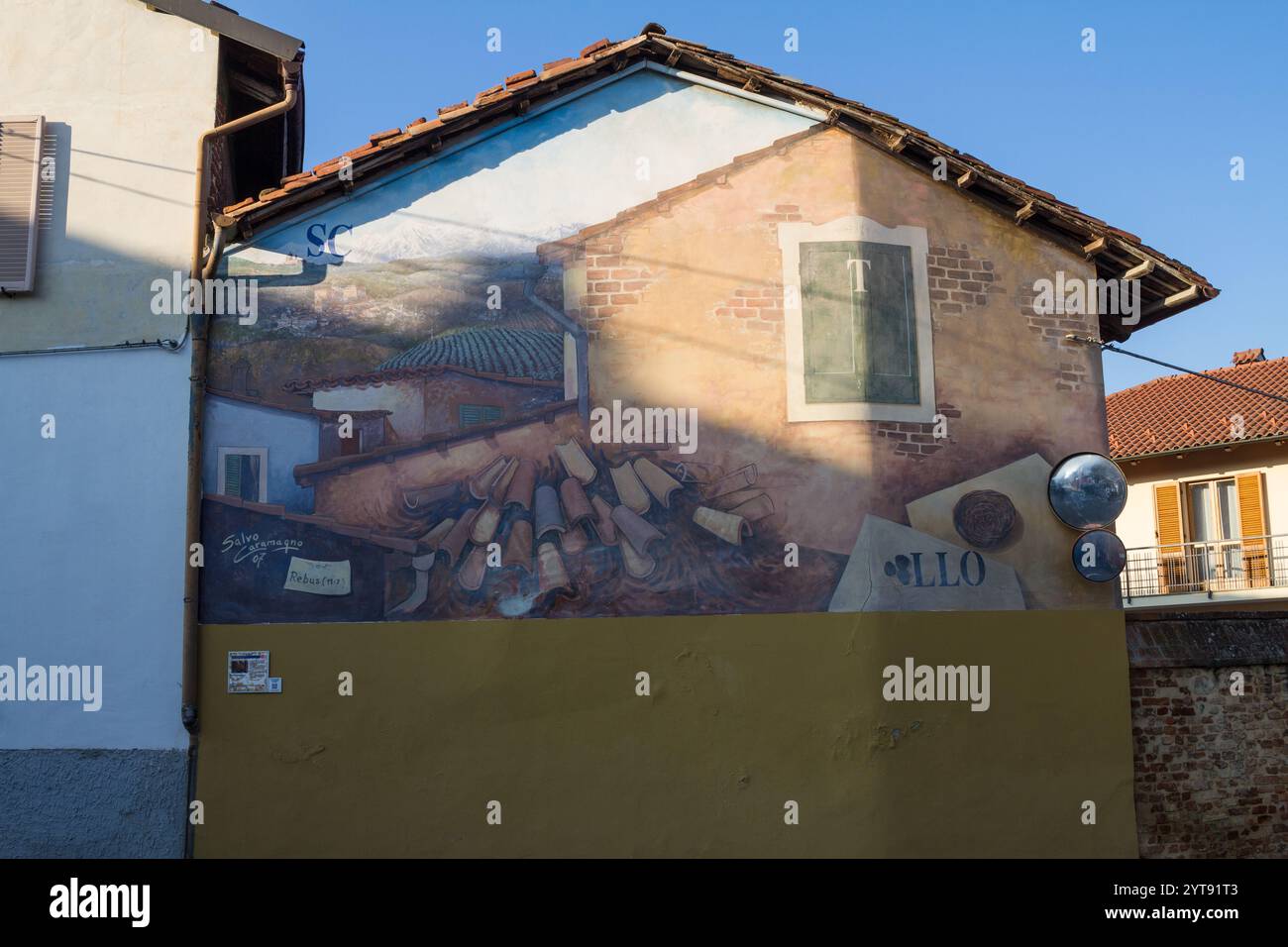 Mural with riddles drawn on the wall in Marentino, Italian village in the countryside near Turin Stock Photo