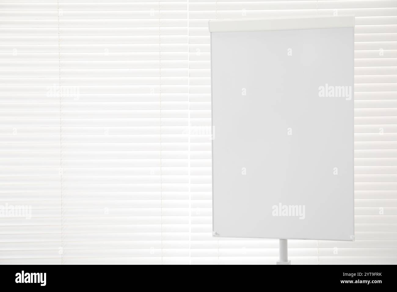 Flip chart near window in office. Mockup for design Stock Photo Alamy