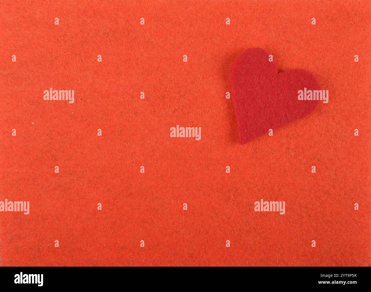 Felt heart on a red background Stock Photo
