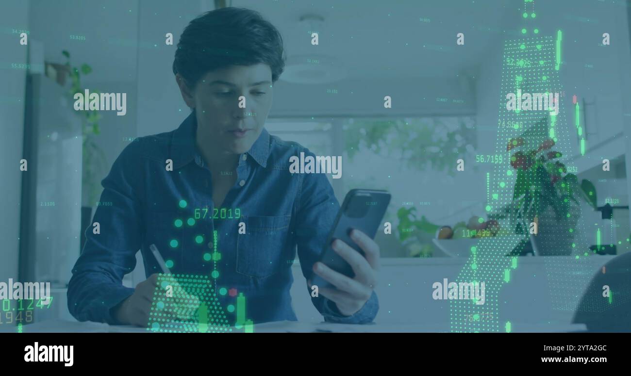 Analyzing financial data image over person using smartphone and writing notes Stock Photo