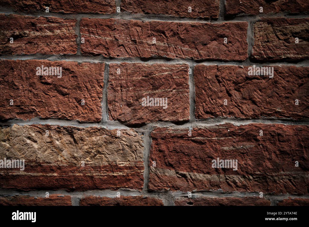 Background with rustic old stone wall pattern. Rough warm sand stone texture. Close-up. Stock Photo