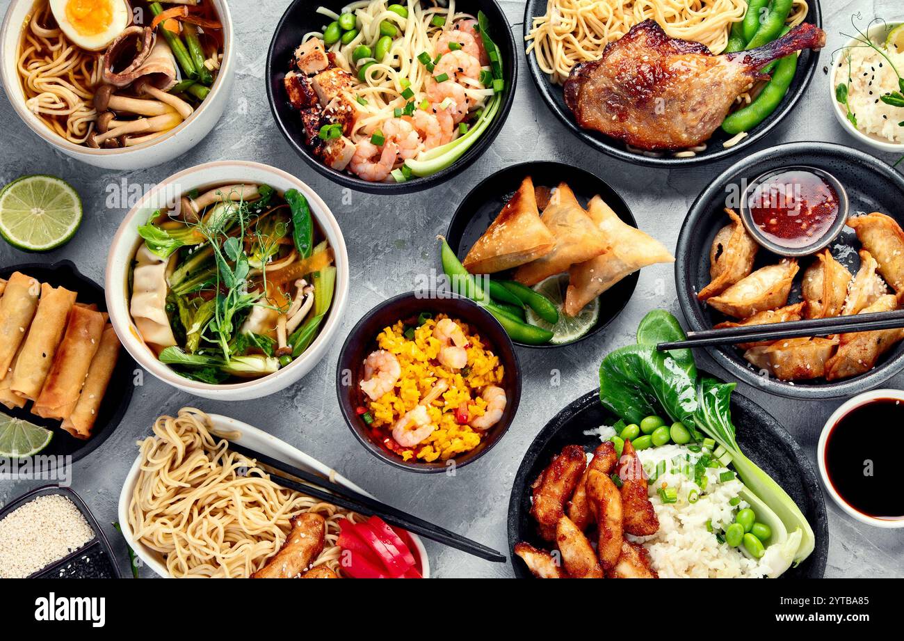 Assorted asian dishes and snacks on dark gray background Stock Photo ...