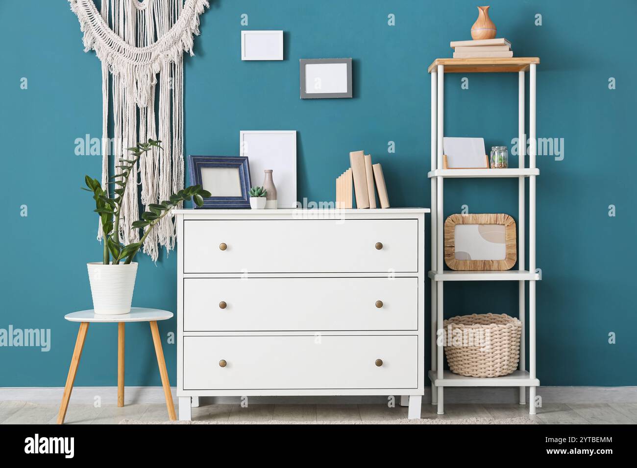 Interior of stylish modern room with commode and shelving unit near ...