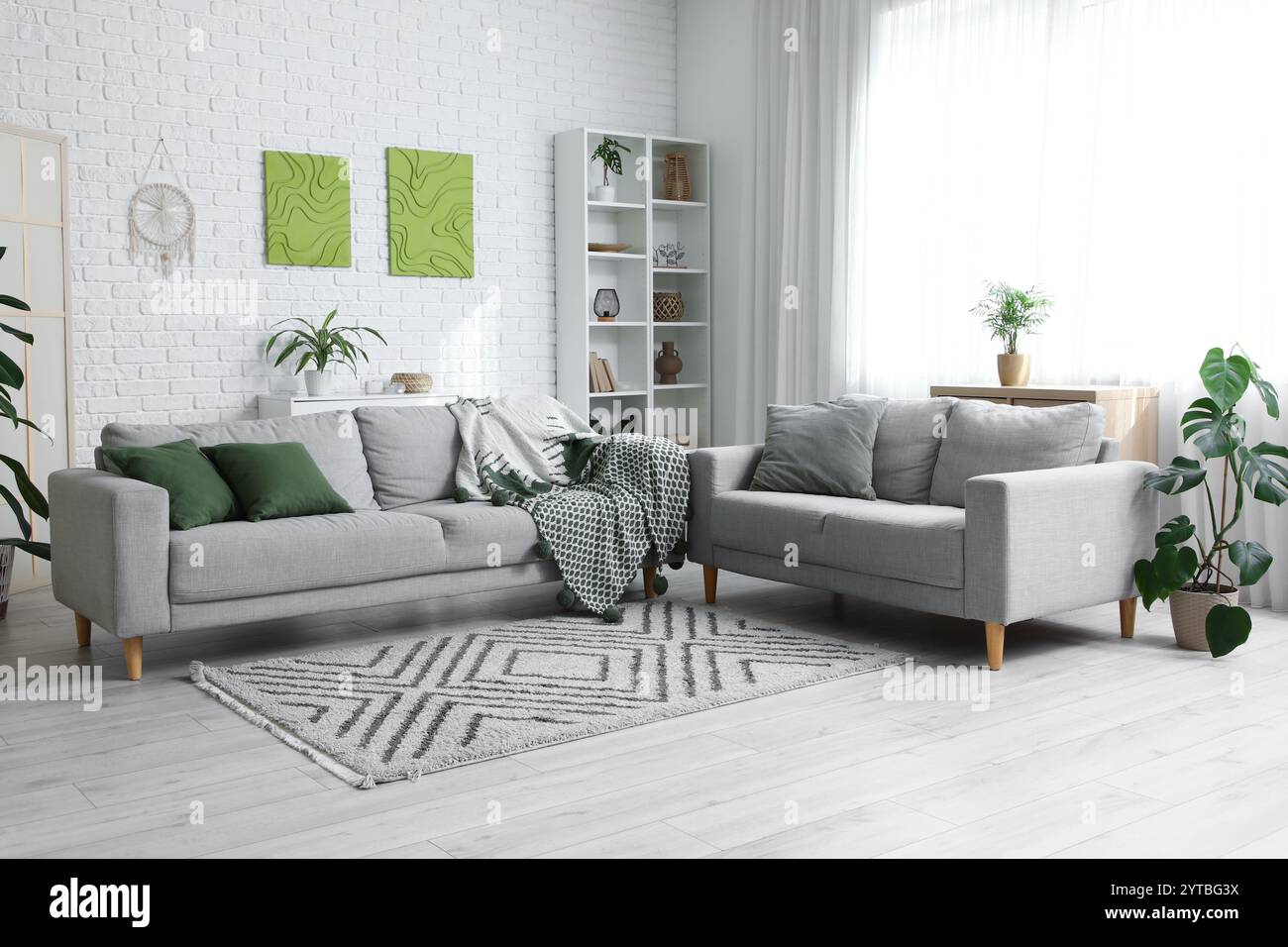 Interior of living room with cozy sofas and pictures Stock Photo - Alamy