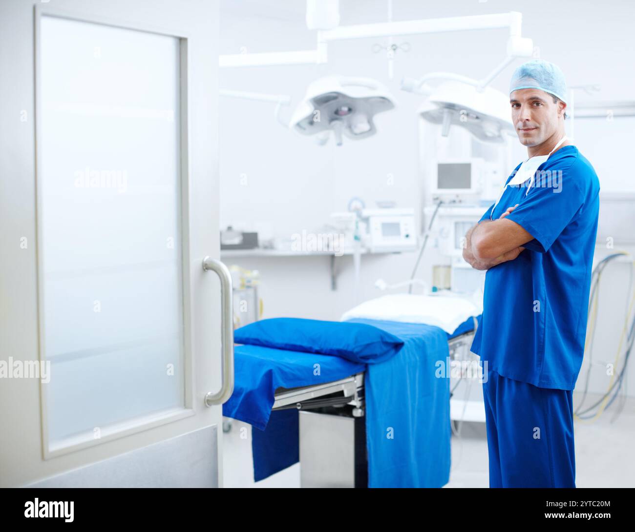 Doctor, surgery and arms crossed with man in hospital for healthcare ...