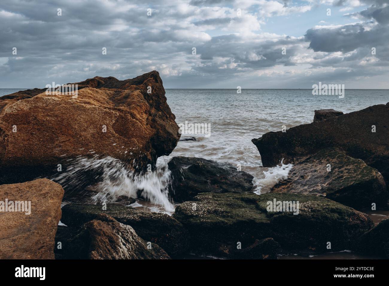 Early morning sunrise over the sea . Some clouds. Stock Photo