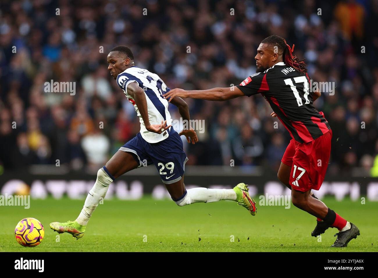 Pape Matar Sarr of Tottenham Hotspur takes on Alex Iwobi of Fulham - Tottenham Hotspur v Fulham, Premier League, Tottenham Hotspur Stadium, London, UK - 1st December 2024 Editorial Use Only - DataCo restrictions apply Stock Photo