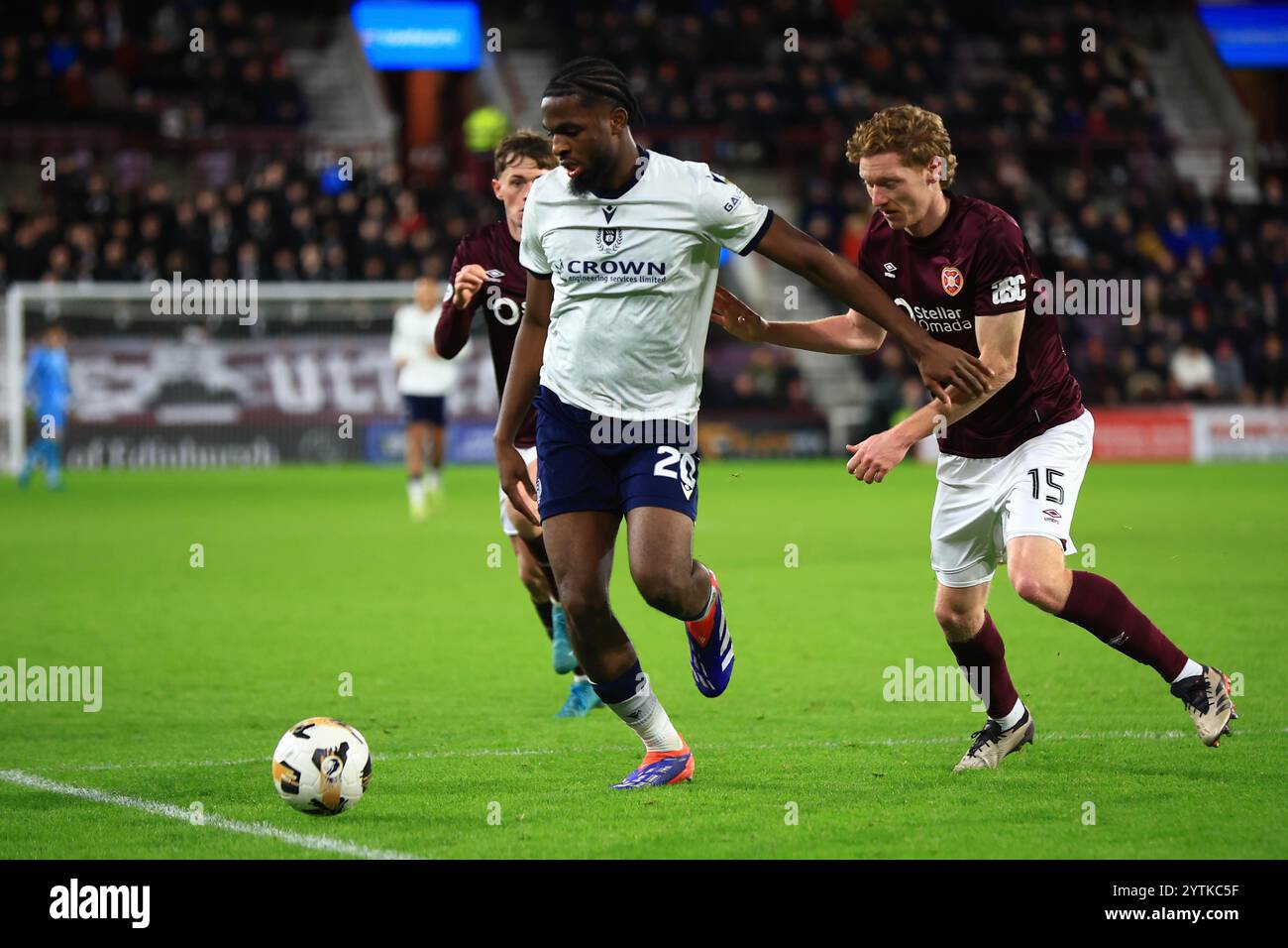 7th December 2024; Tynecastle Park, Edinburgh, Scotland: Scottish Premiership Football, Heart of Midlothian versus Dundee; Billy Koumetio of Dundee shields the ball from Kye Rowles and James Penrice of Heart of Midlothian Stock Photo