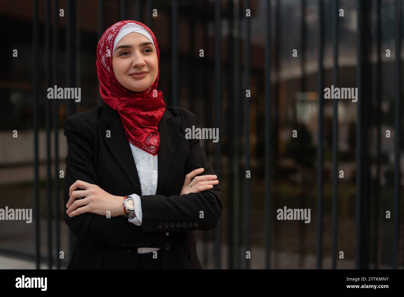 Portrait of a young confident Muslim business woman in hijab standing ...