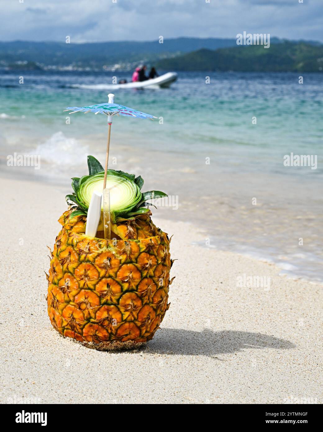 Tropical drink - pineapple fruit cocktail in white sand beach paradise ...
