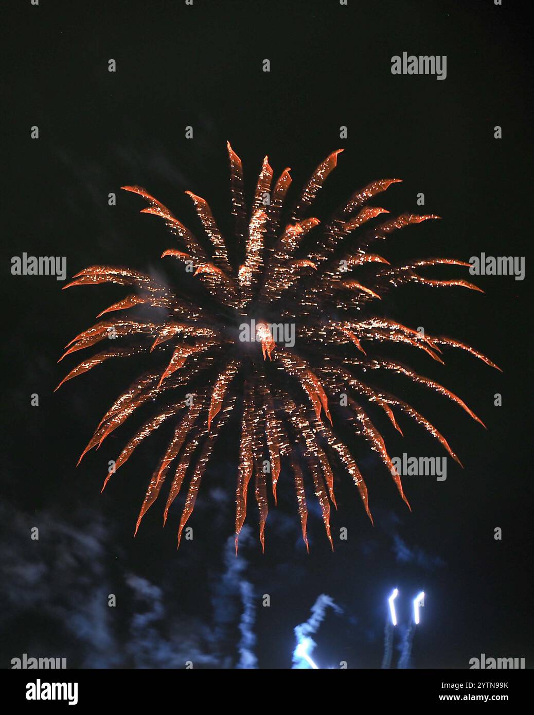 dramatic orange firework exploding in a black sky Stock Photo - Alamy