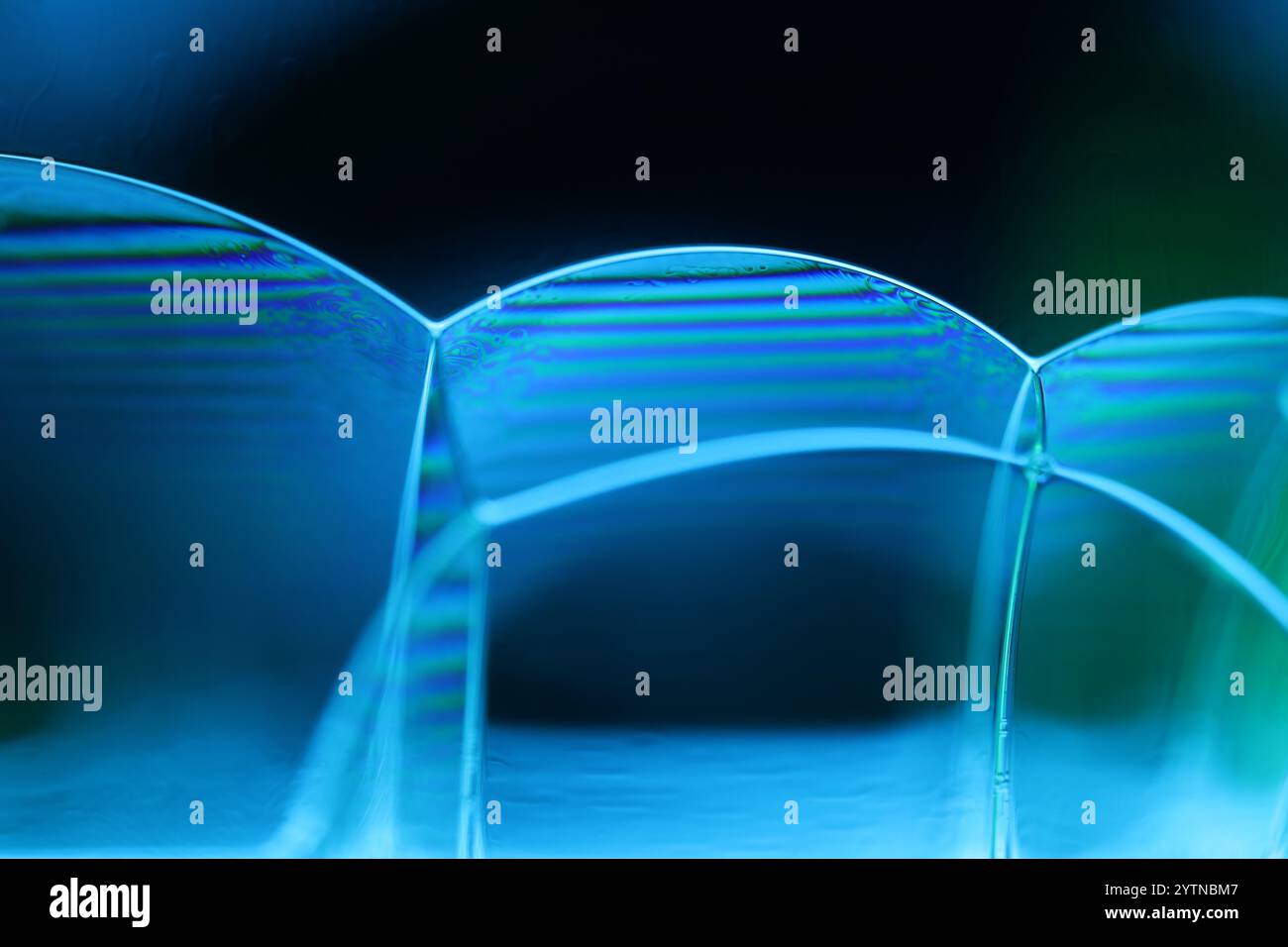 Blue fluid reflections on black background, liquid abstraction, colour waves, deep dark backgrounds Stock Photo