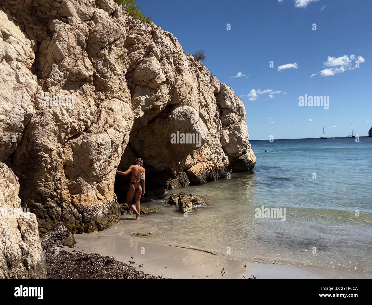 Women facing the Mediterranean Sea next to a cove. - Smartphone Captured Stock Image