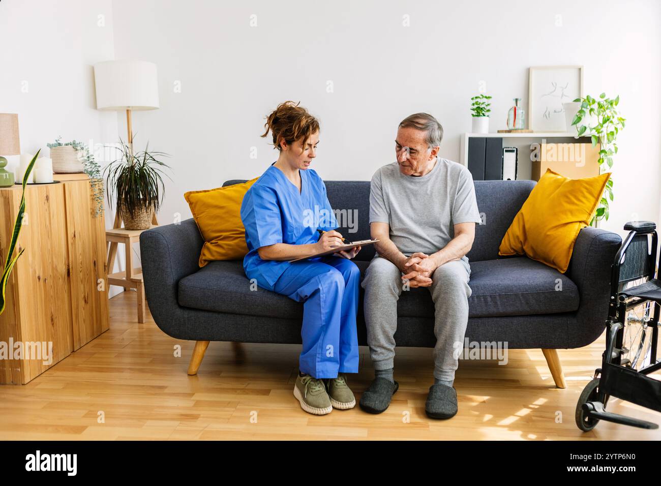 Young female caregiver in blue hi res stock photography and images Alamy