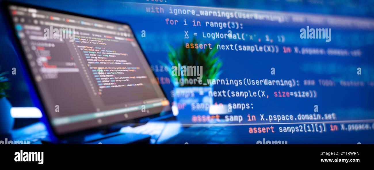 Work from home. Programmer coding code on notebook screen at Stock Photo