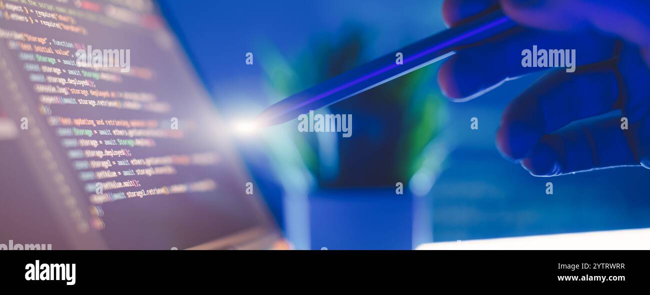 Work from home. Programmer coding code on notebook screen at Stock Photo