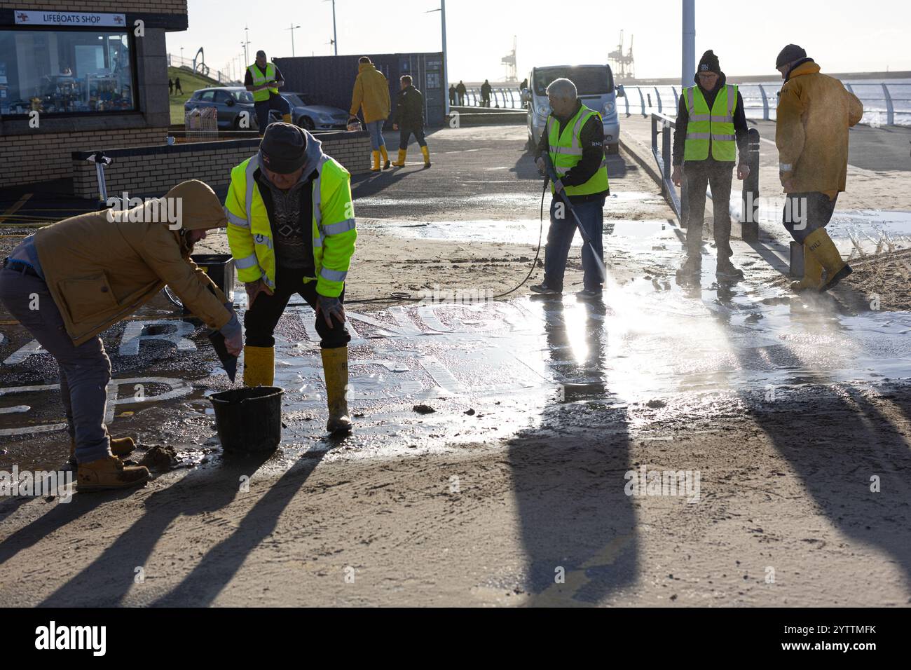 Port Talbot, Wales, UK. 8th Dec 2024. RNLI Staff and Volnteers clean mud and sand from the slipway on Aberavon Beach. Sean Pursey/ Alamy Live News Stock Photo