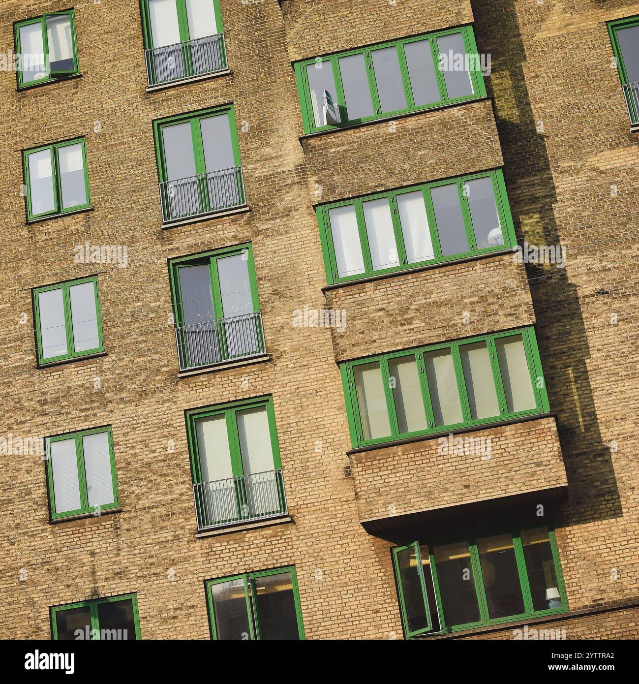 Full frame image of a residendial block with green windows Stock Photo ...